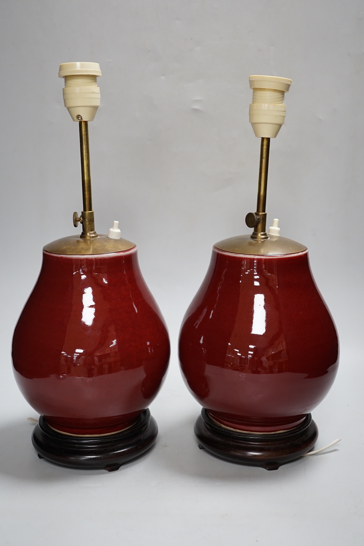 A pair of Chinese sang de boeuf glazed vases, mounted as lamps 23cm high excluding light fitting